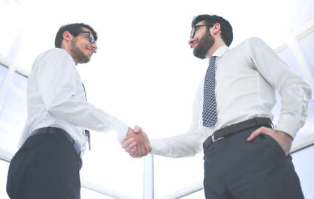 bottom view.handshake business partners standing in the officeの写真素材