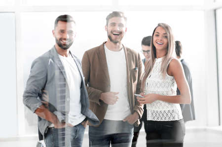 three young employees of the company standing in the office
