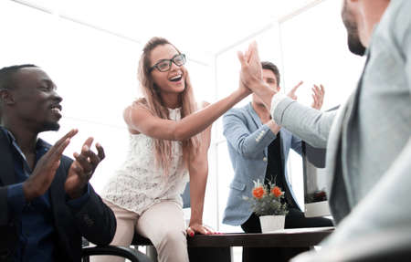 smiling employees giving each other a high five