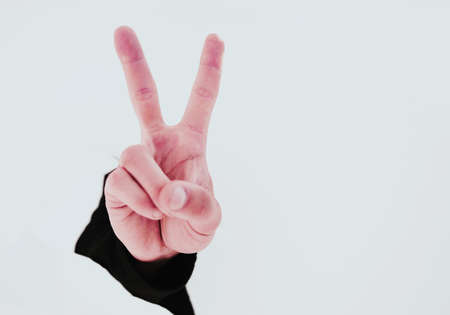 close up.businessman showing his index finger through the torn pの写真素材