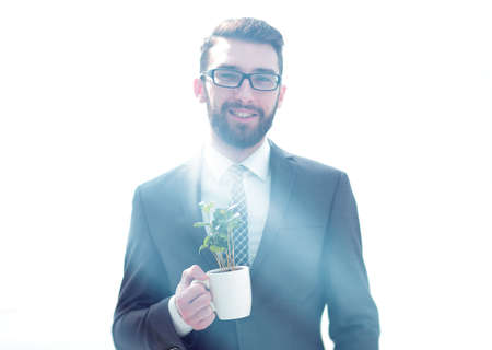 close up.businessman is holding a green young shootの写真素材