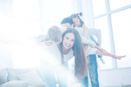 happy parents have fun with their children in the living roomの写真素材