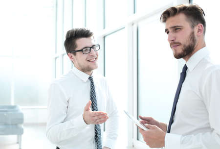 business colleagues talk standing in the new officeの写真素材