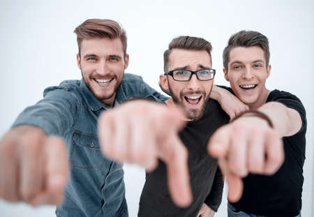 group of smiling male friends pointing at youの写真素材