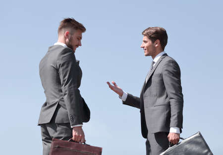 business colleagues, discuss their ideas standing on the streetの写真素材