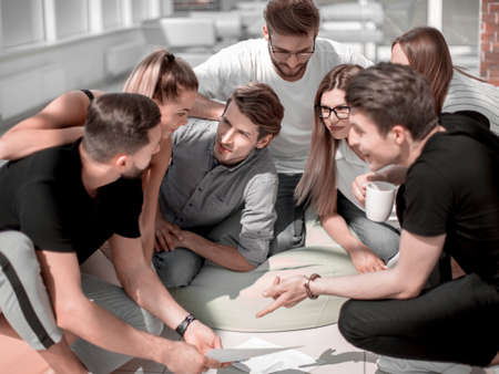 young entrepreneurs discussing business documents at an informal meeting