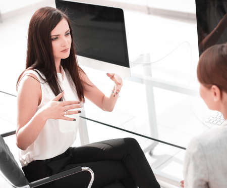 employees of the company discuss work issues at the desktop