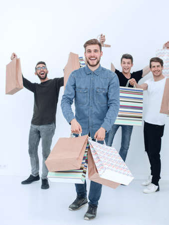 group of cheerful young mens with shopping bagsの写真素材