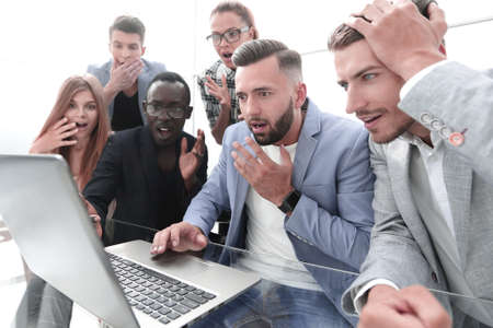 Frustrated females and males sales managers working in showroom, looking at laptop monitorの写真素材