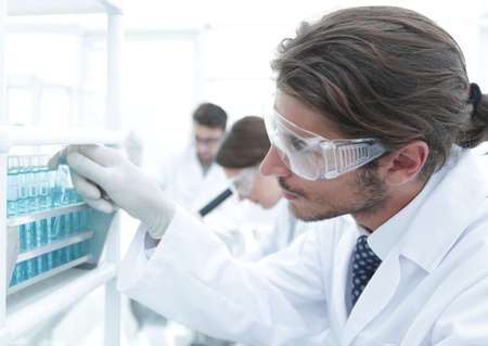 close-up of a happy male scientist wearing safety glasses