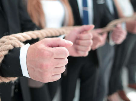fists of businessmen, trying to get rid of ropesの写真素材