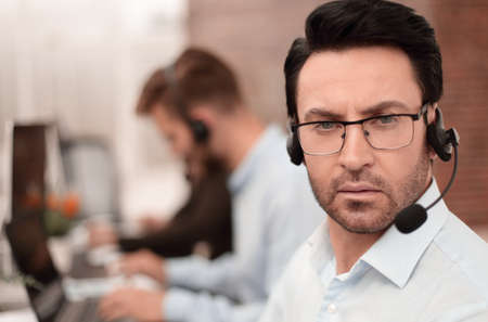 close up.call center operator on the background of the office