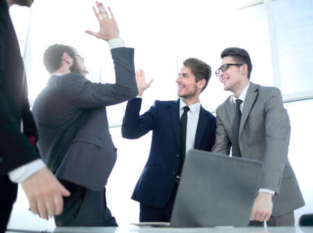 happy coworkers giving each other a high five