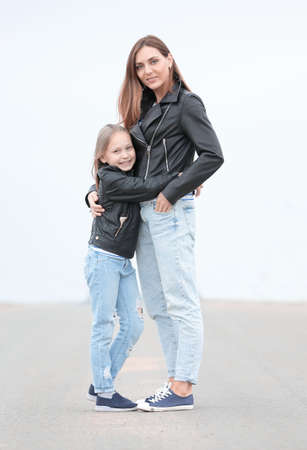 portrait of mother and daughter standing together