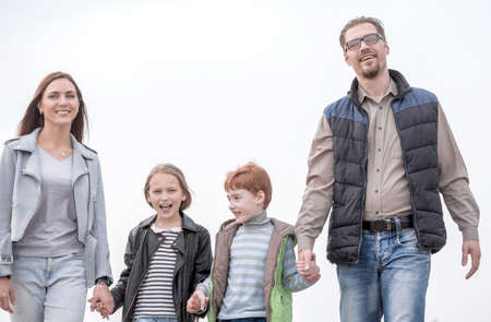 happy parents with their children holding each others handsの写真素材