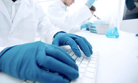 close up.scientist typing on computer keyboard.