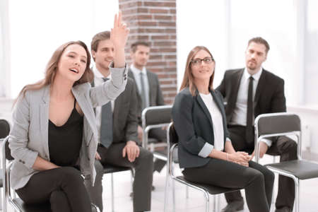 business woman raising hand during seminarの写真素材