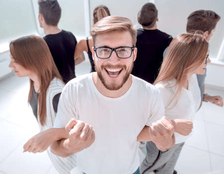 young man standing in a circle with a business team
