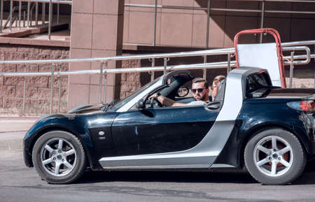convertible on a city street.