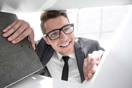 man looks at the folder with documents