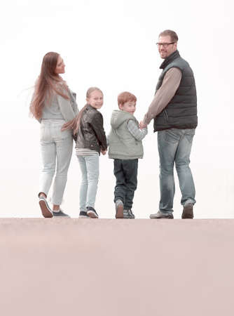 rear view.happy family walking the road together