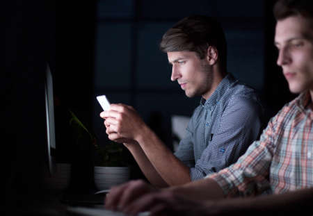 office staff working on the computer in the dark