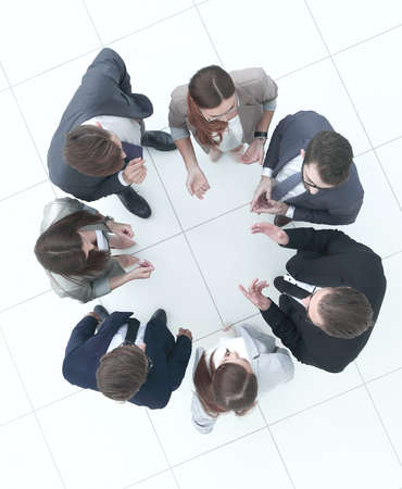 top view.business team discussing something standing in a circle