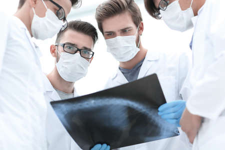 male doctors looking attentively at x-ray