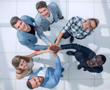 Concept of teamwork. High angle top view of youth hipster folded her hands stacked on topの写真素材