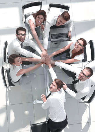top view of young business people putting their hands togetherの写真素材