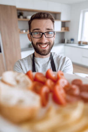 plate of sandwiches in the hands of an attractive man