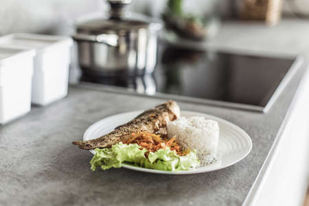 fish with garnish on the kitchen tableの写真素材