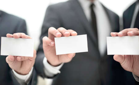group of young entrepreneurs showing their business cards