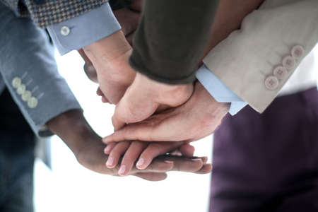 close up.business team putting their hands together.