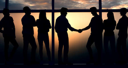 handshake two like-minded near a large window.の写真素材