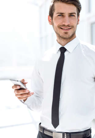 close up.smiling businessman with smartphoneの写真素材