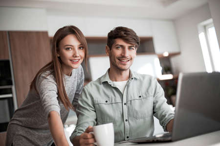 Young couple browsing their Bank accounts using laptop computer