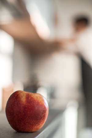 close up. a man washes an Apple under the tapの写真素材