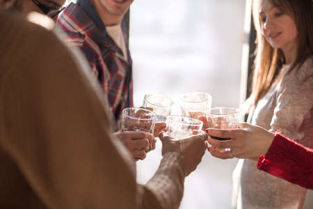 background image of a glass of juice in the hands of the young coupleの写真素材