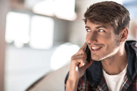 close up. young man talking on the phoneの写真素材