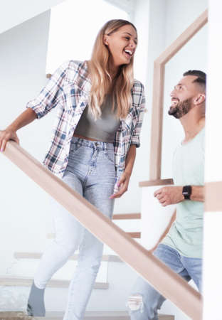 happy couple on the stairs in their new apartment.