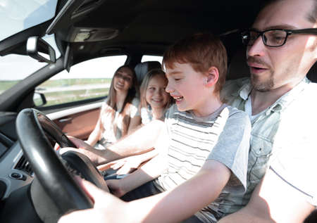 funny father and his little son driving a carの写真素材