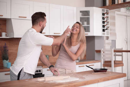young couple communicates in the home kitchenの写真素材