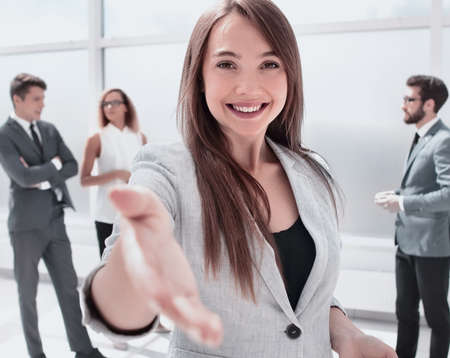 young business woman holding out her hand for a handshakeの写真素材