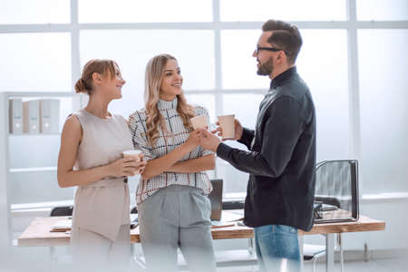 business team discussing something standing in the officeの写真素材