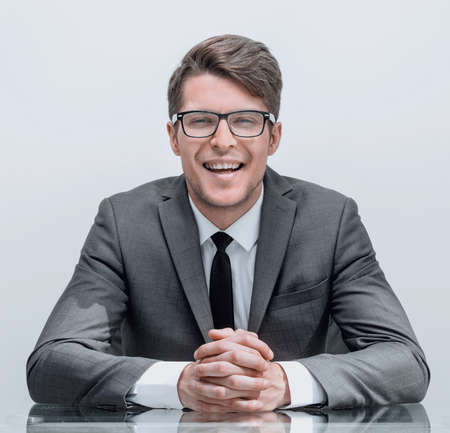close up. smiling businessman sitting at his Desk.の写真素材