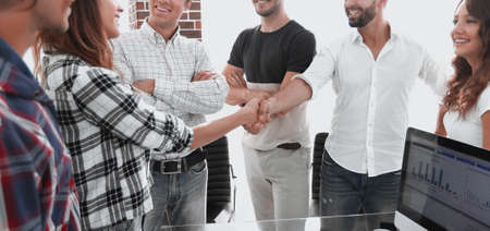 business handshake in modern office