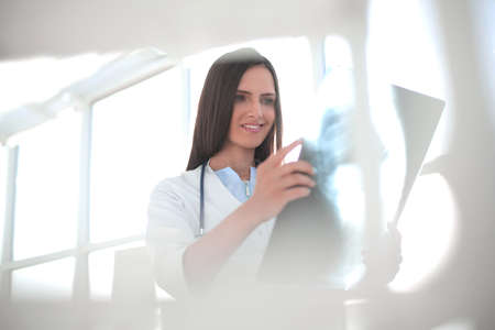 close up. female therapist looking at x-ray .