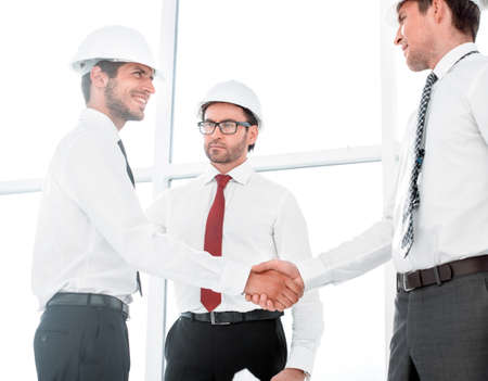 Two architects shaking hands after a meeting in office