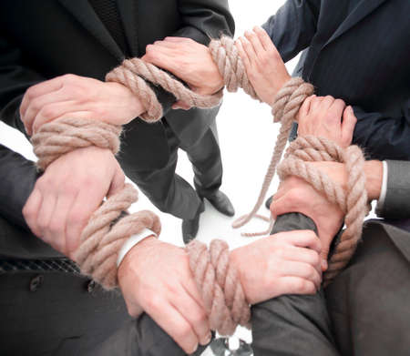 closeup.unified business team ,tied a strong rope.の写真素材